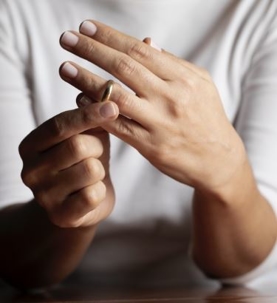person taking off wedding ring
