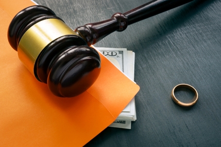 gavel, money, and a wedding ring
